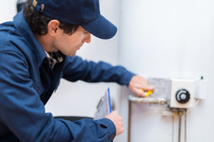 plumber handling an emergency with a water heater