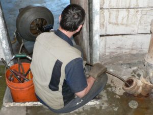 plumber snaking a drain