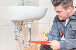 plumber fixing a bathroom sink