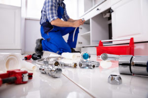 plumber fixing a clogged drain