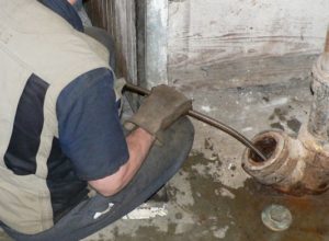 plumber snaking out a drain